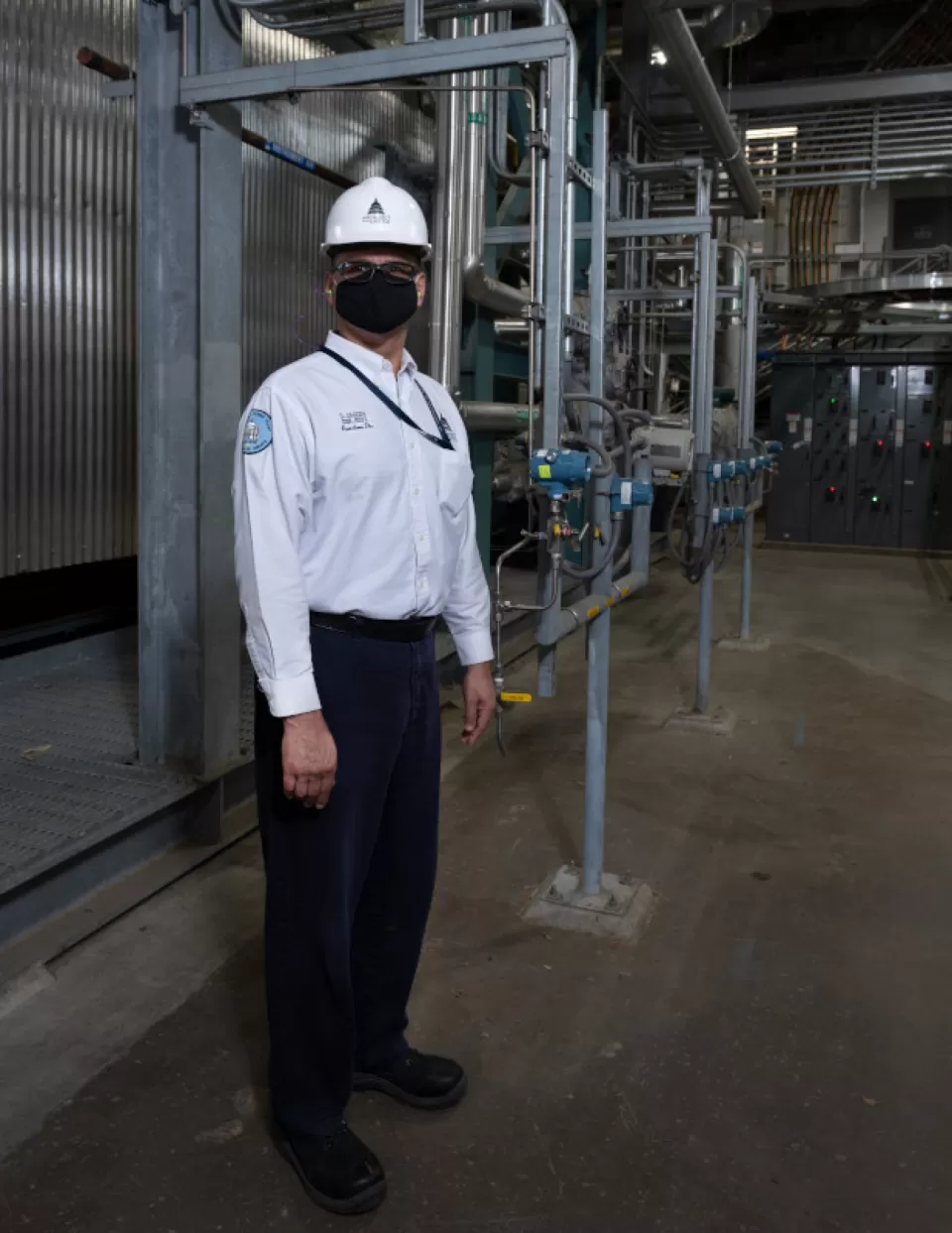 Sequester Team Leader Ladislaus “Dave” Jagoda in front of the cogeneration system at the Capitol Power Plant