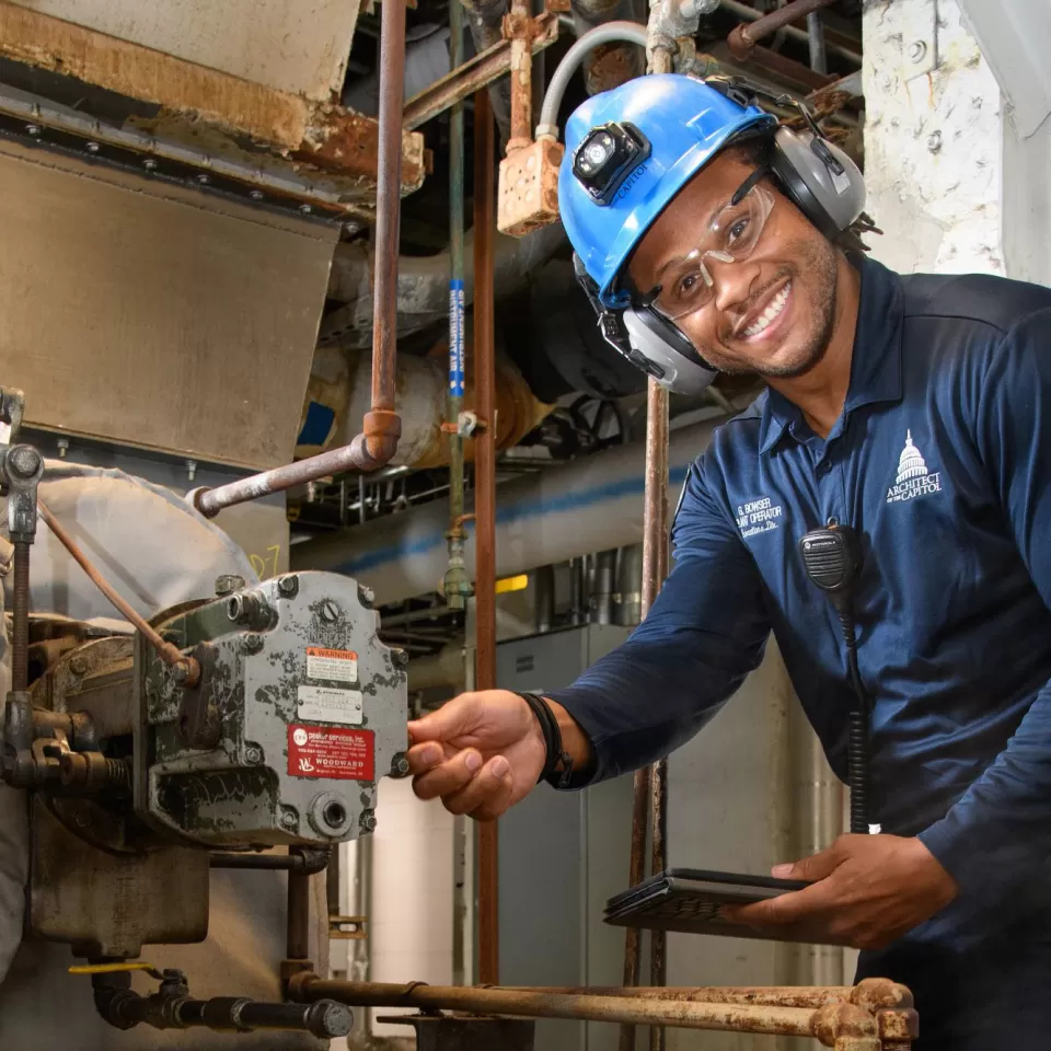 Gary Bowser inspects a boiler fan to ensure that it is properly lubricated and that safety systems are working correctly.