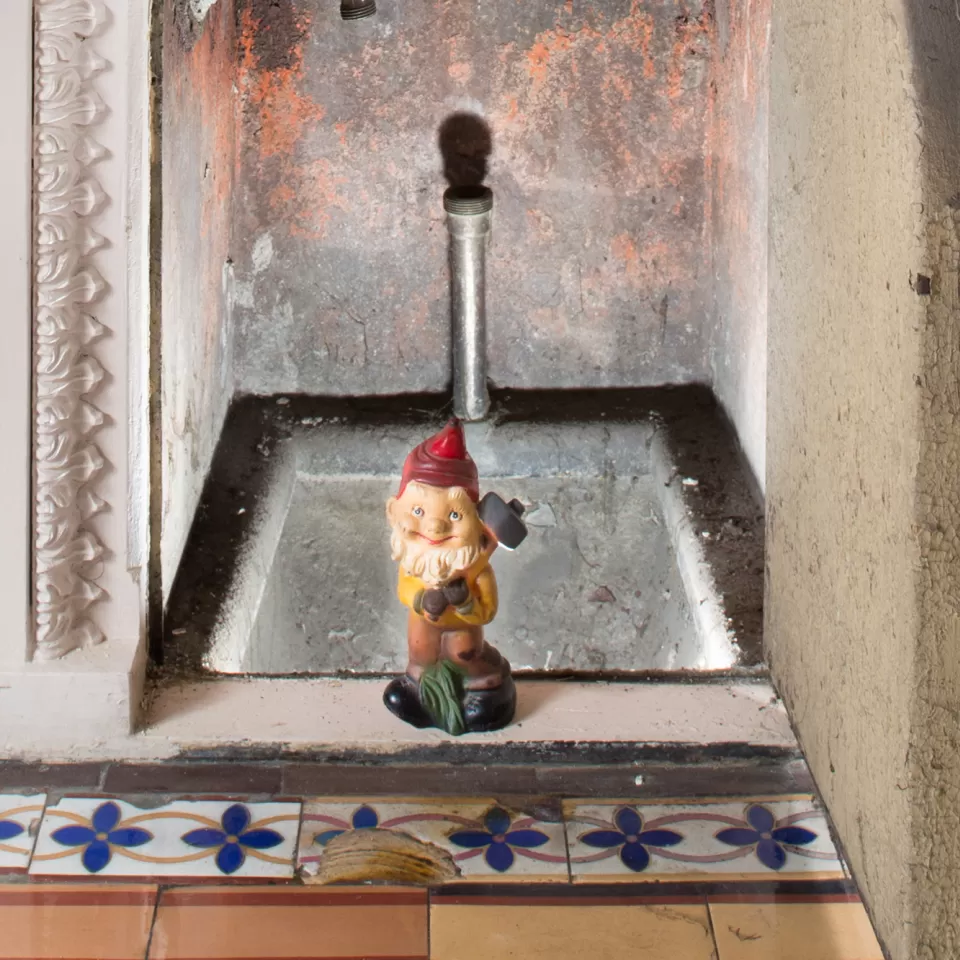 Gnome statue in tiny doorway.