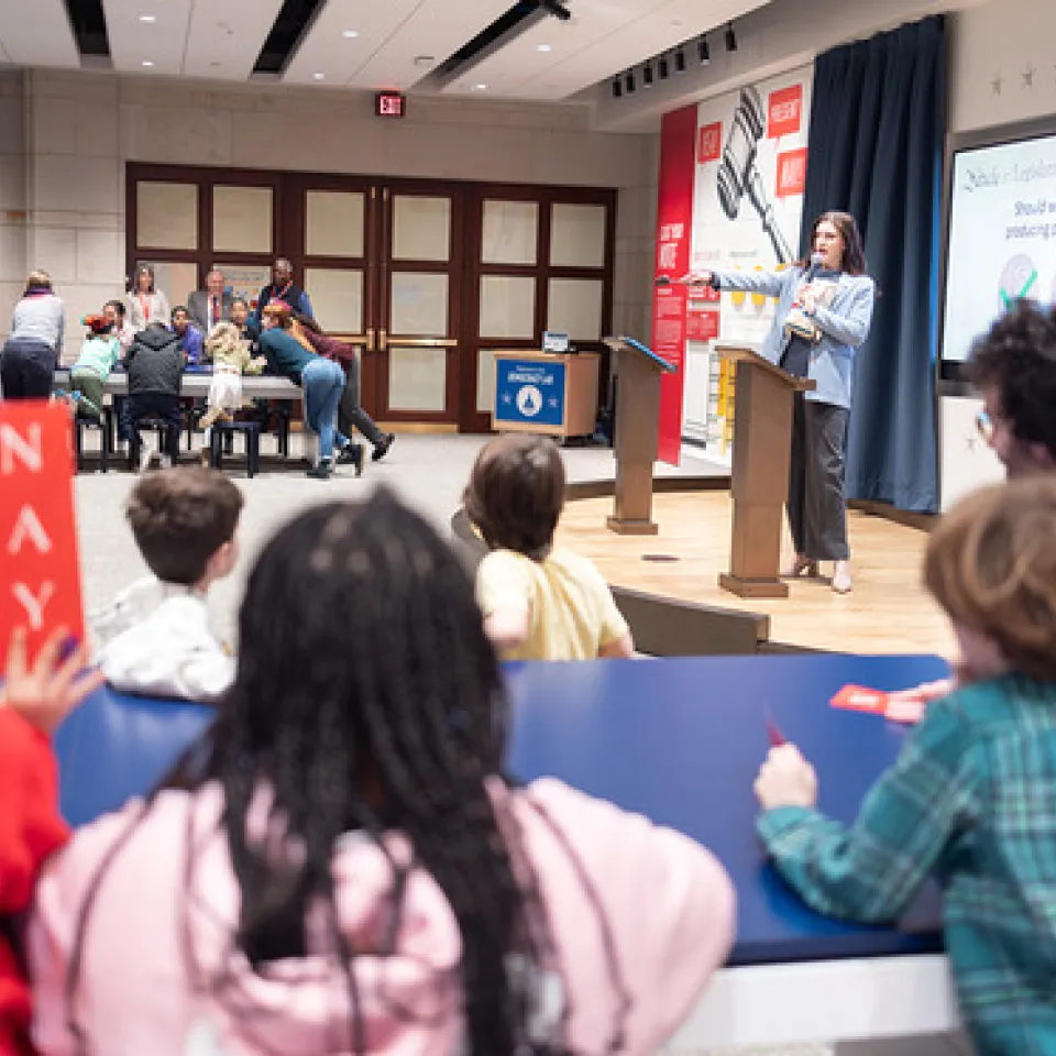 Group of kids listening to a presenter.