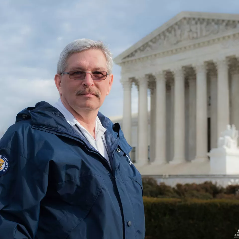 AOC's Joel Evans standing with the Supreme Court Building in the background.