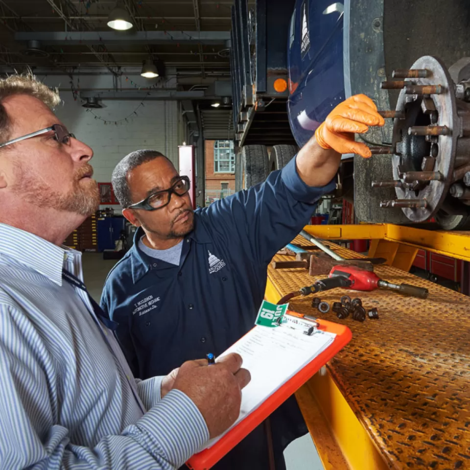 Members of Capitol Grounds and Arboretum inspect a vehicle operating on the U.S. Capitol campus.