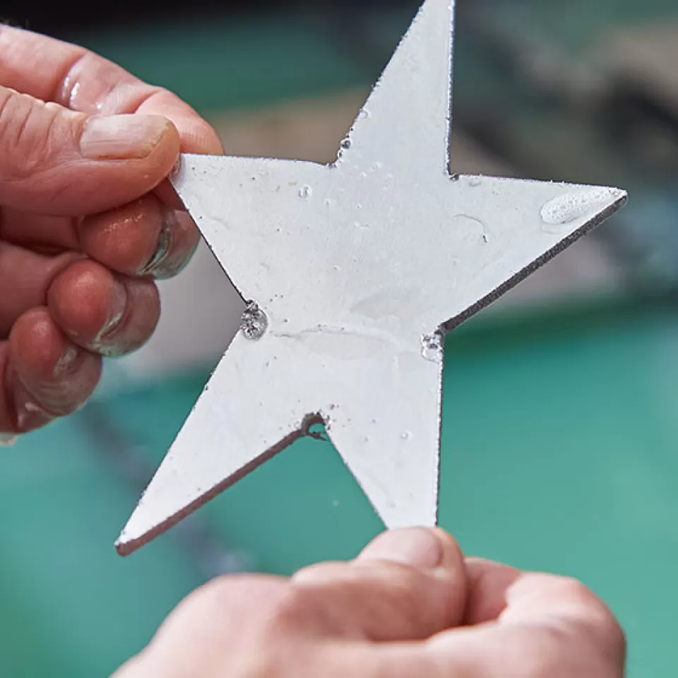 A five-pointed star was cut within seconds by the Architect of the Capitol Sheet Metal Shop.