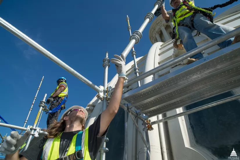 Placement of elements of scaffold that will reach, and eventually cover, the entire Capitol Dome enabling restoration work on Dome.
