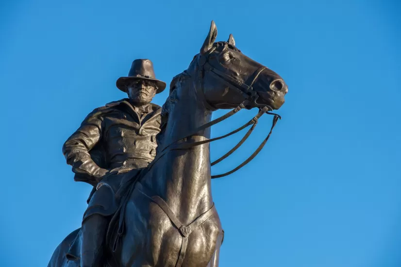 Bronze statue of a person on a horse.