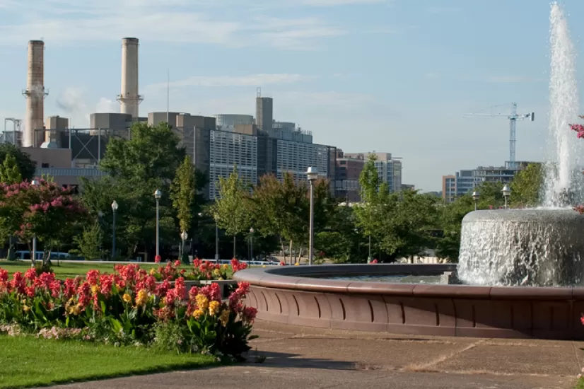 Smokestacks, flowers, fountain.