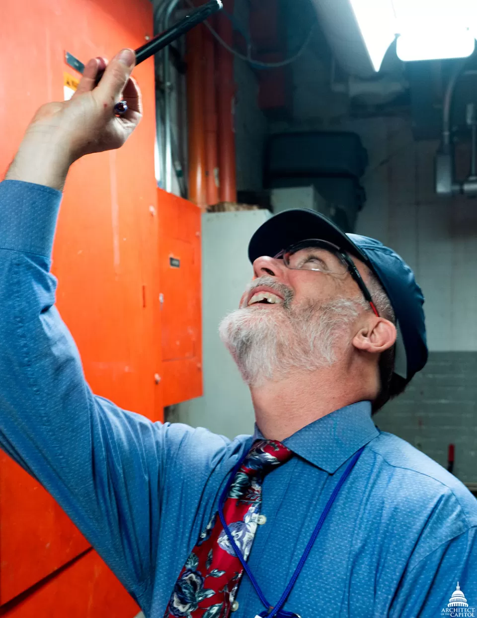 An AOC employee inspects the ceiling of a mechanical space in the U.S. Capitol.