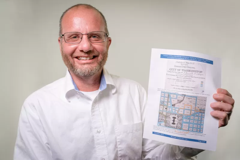 Jim Kaufmann, Capitol Grounds and Arboretum Director, pictured with a copy of the 1891 street sweeping map.