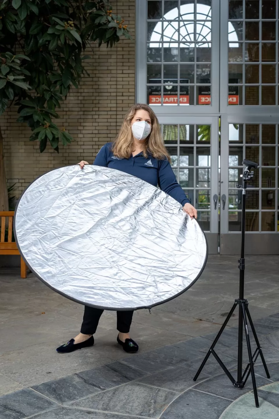 Anderson tests how additional lighting from a reflector might help the presentation be better visible on-screen.