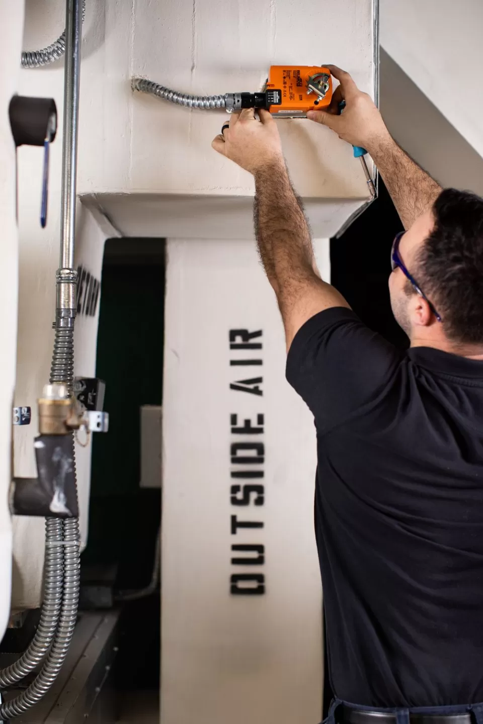 HVAC Shop employee working on a retro-commissioning project.