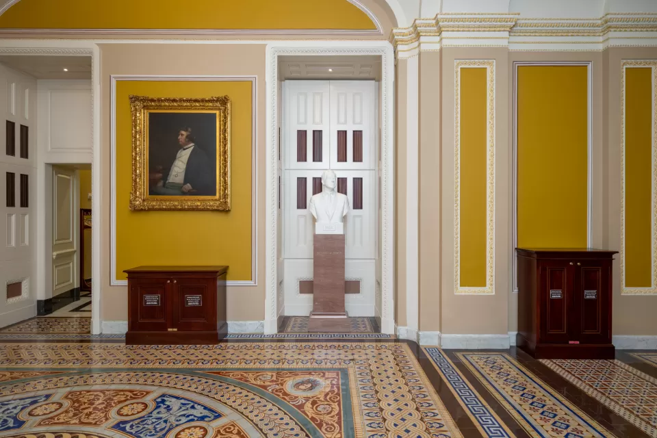 View of a wall with art in a hallway.