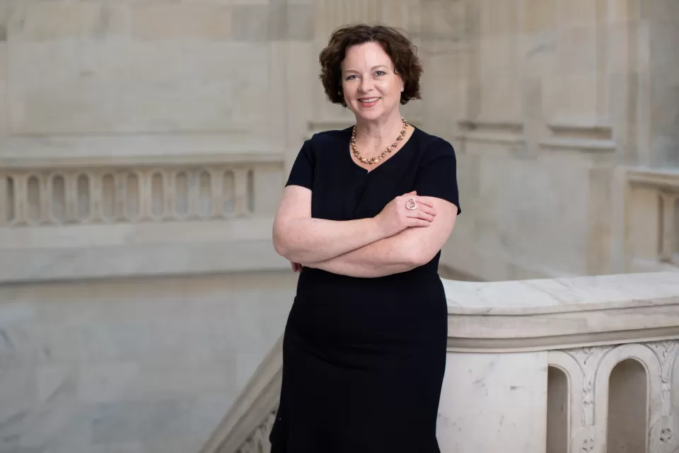 Portrait of a person standing with arms crossed.