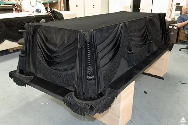 In 2006, the Architect of the Capitol carefully restored the fabric that covers the catafalque constructed by Job W. Angus and others to hold President Lincoln's casket as he lay in state.