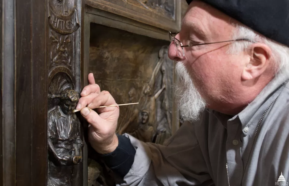 Conservator working on the Amateis Doors.