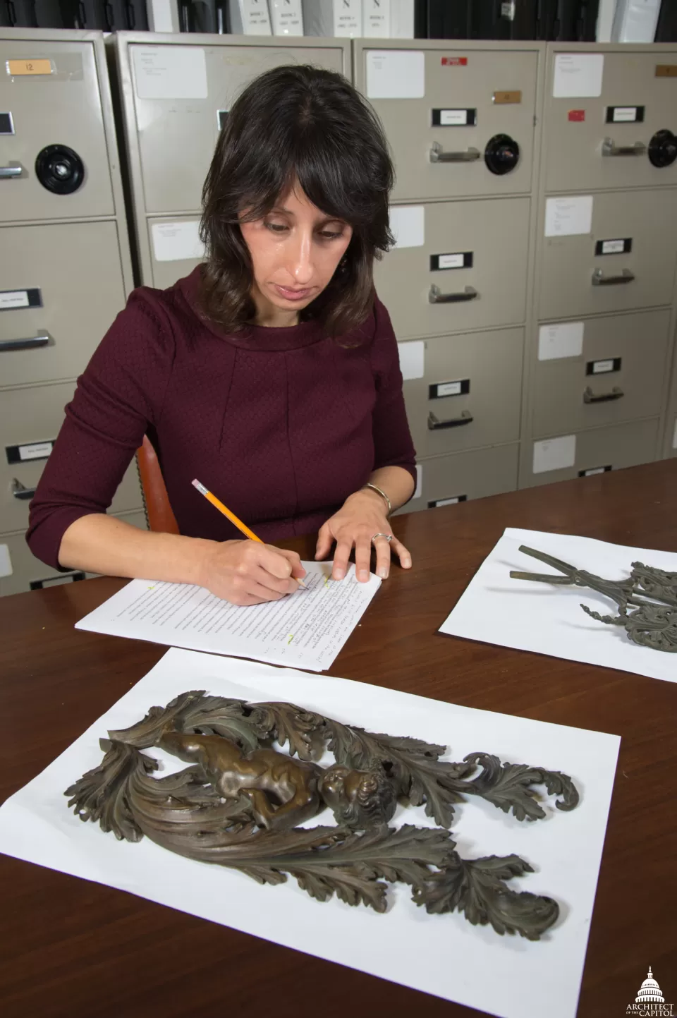 Jennifer Blancato, Office of the Curator, carefully analyzes art.
