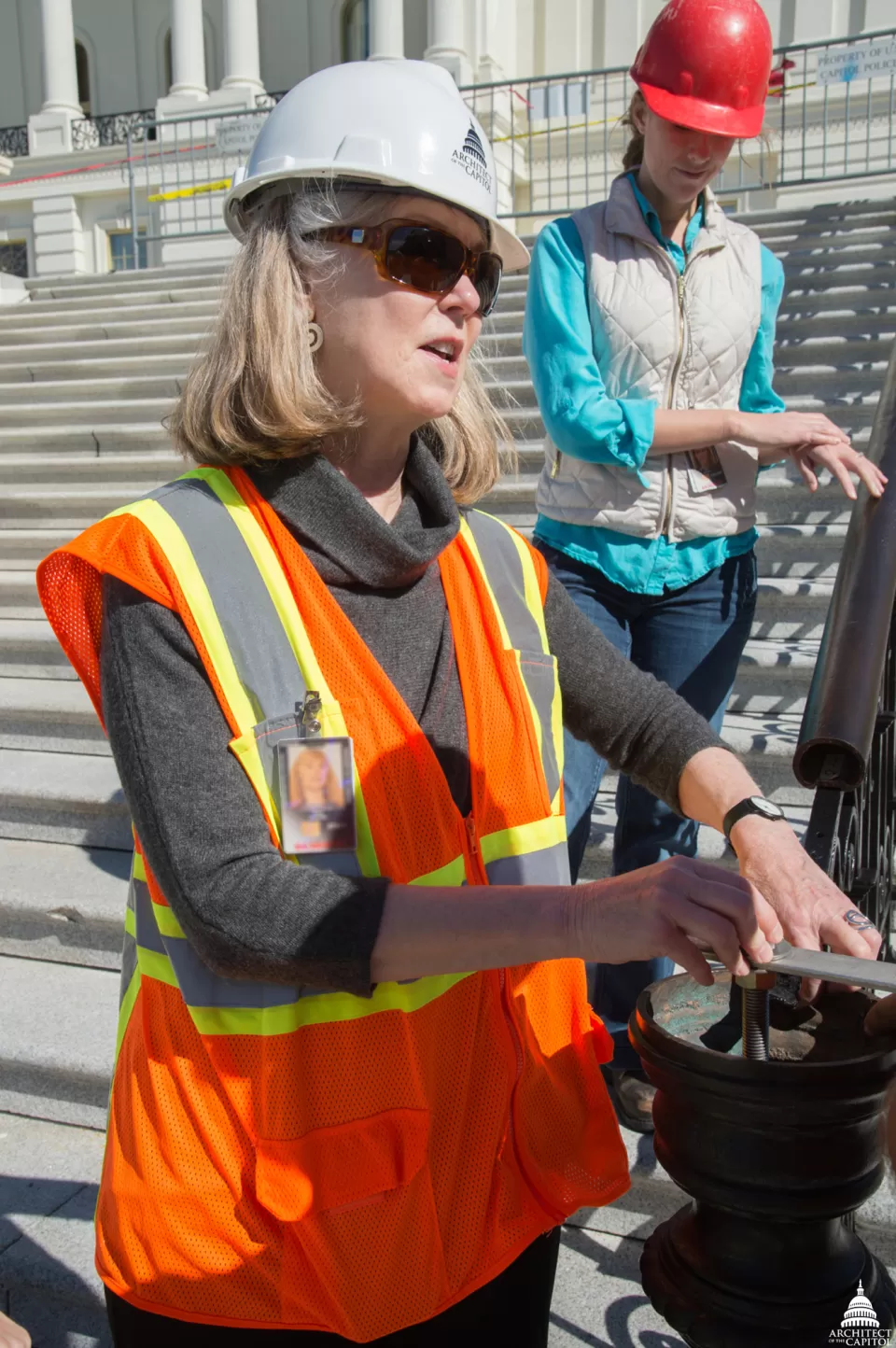 Historic Preservation Officer Mary Oehrlein inspects stone at the Capitol.