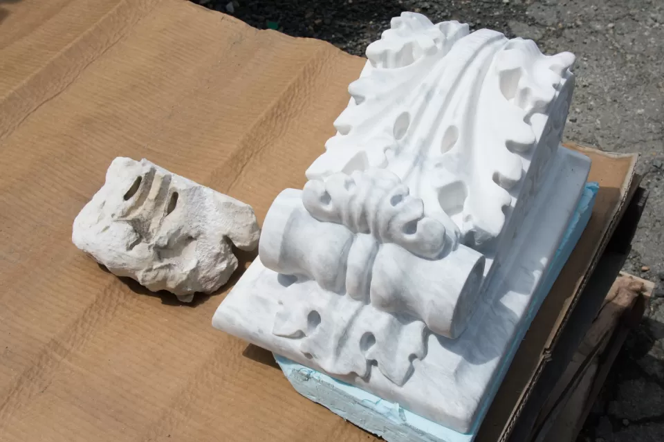 Piece of a deteriorated modillion or bracket from the U.S. Capitol (left) next to a newly carved one (right).