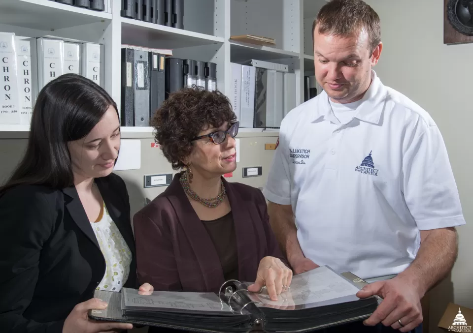 AOC's Erin Nelson, Michele Cohen and Scott Luketich review old floor plans.