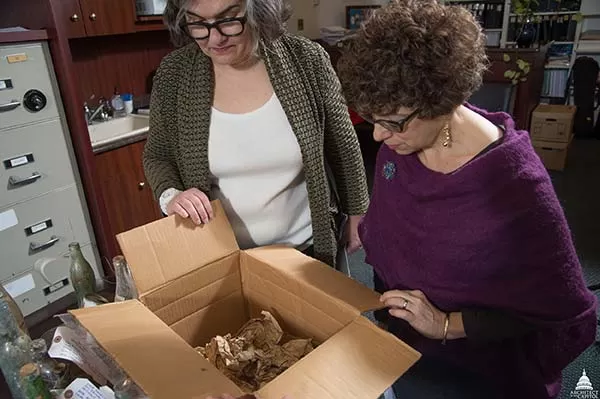 Curators review the historic items that were found during the initial phase of the Cannon Renewal project.