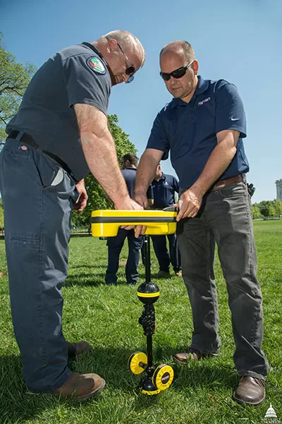 AOC employees test an underground utility locator on the West Front lawn of the U.S. Capitol.