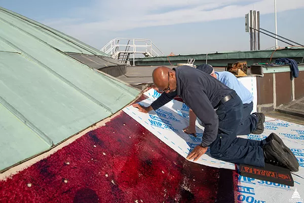 Waterproof membrane being installed before the copper wall flashing is placed at the base of the U.S. Capitol Senate cupola.