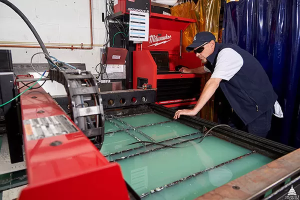 An Architect of the Capitol Sheet Metal Shop Supervisor works the plasma cutter, which only requires one person to operate.