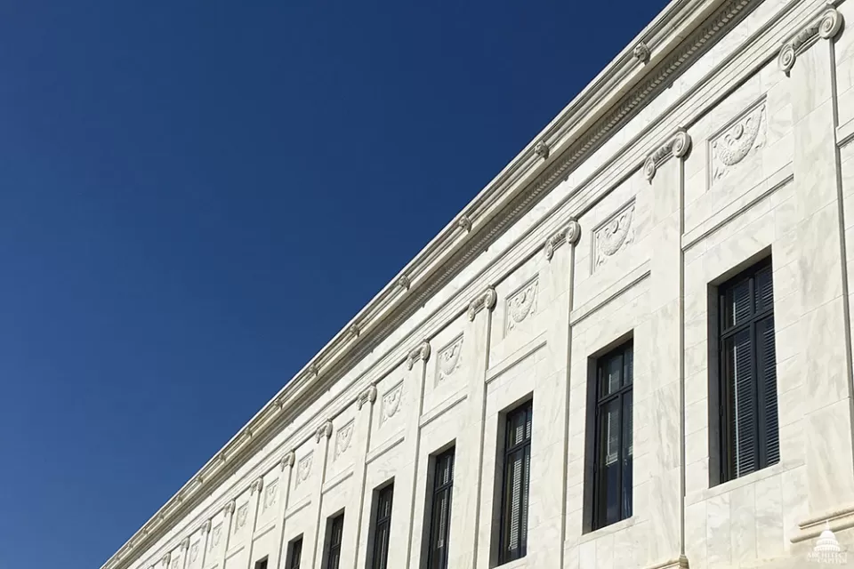 Stone carved lions on the marble facade of Supreme Court Building. 