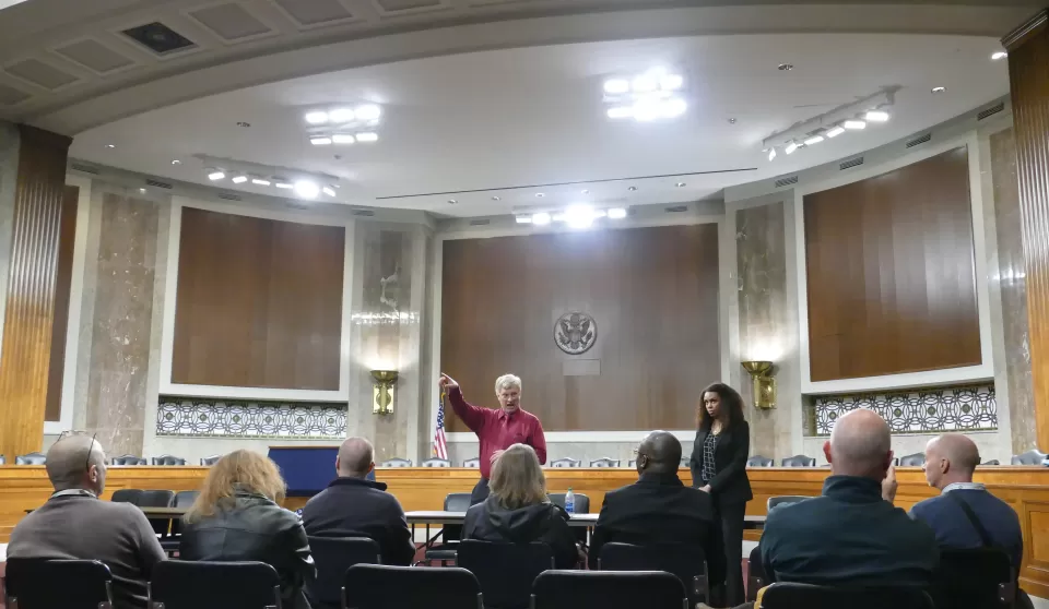 Michael Shirven, Assistant Superintendent, and Alyssa Perron, Mechanical-Energy Engineer, explain hearing room lighting upgrades to visitors.