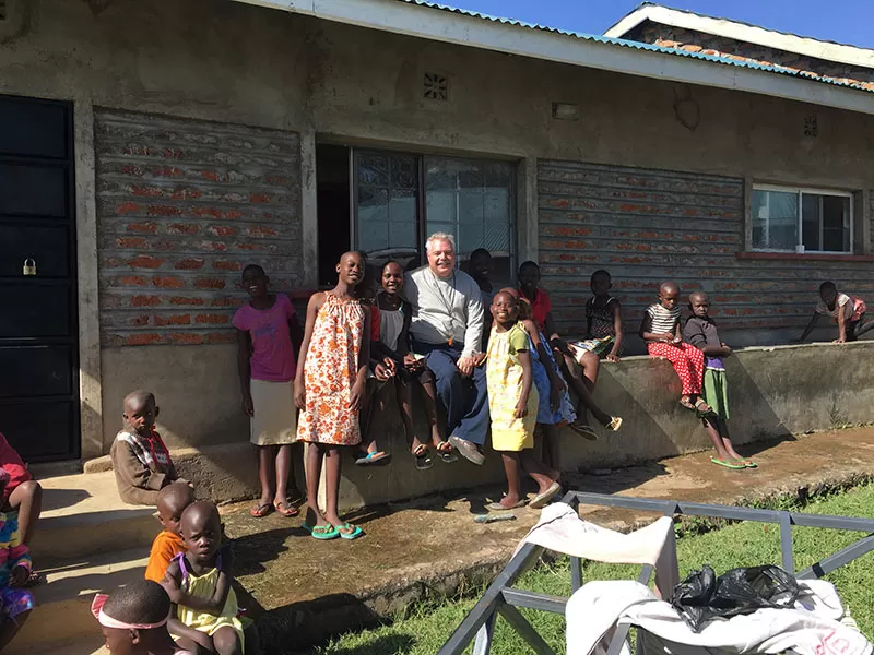 Bill Burns visits with children from the orphanage.