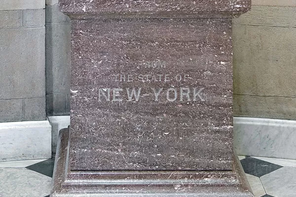 The pedestal of George Clinton's statue in the U.S. Capitol reads "The State of New York."