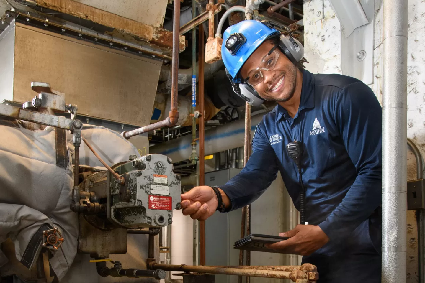 Gary Bowser inspects a boiler fan to ensure that it is properly lubricated and that safety systems are working correctly.