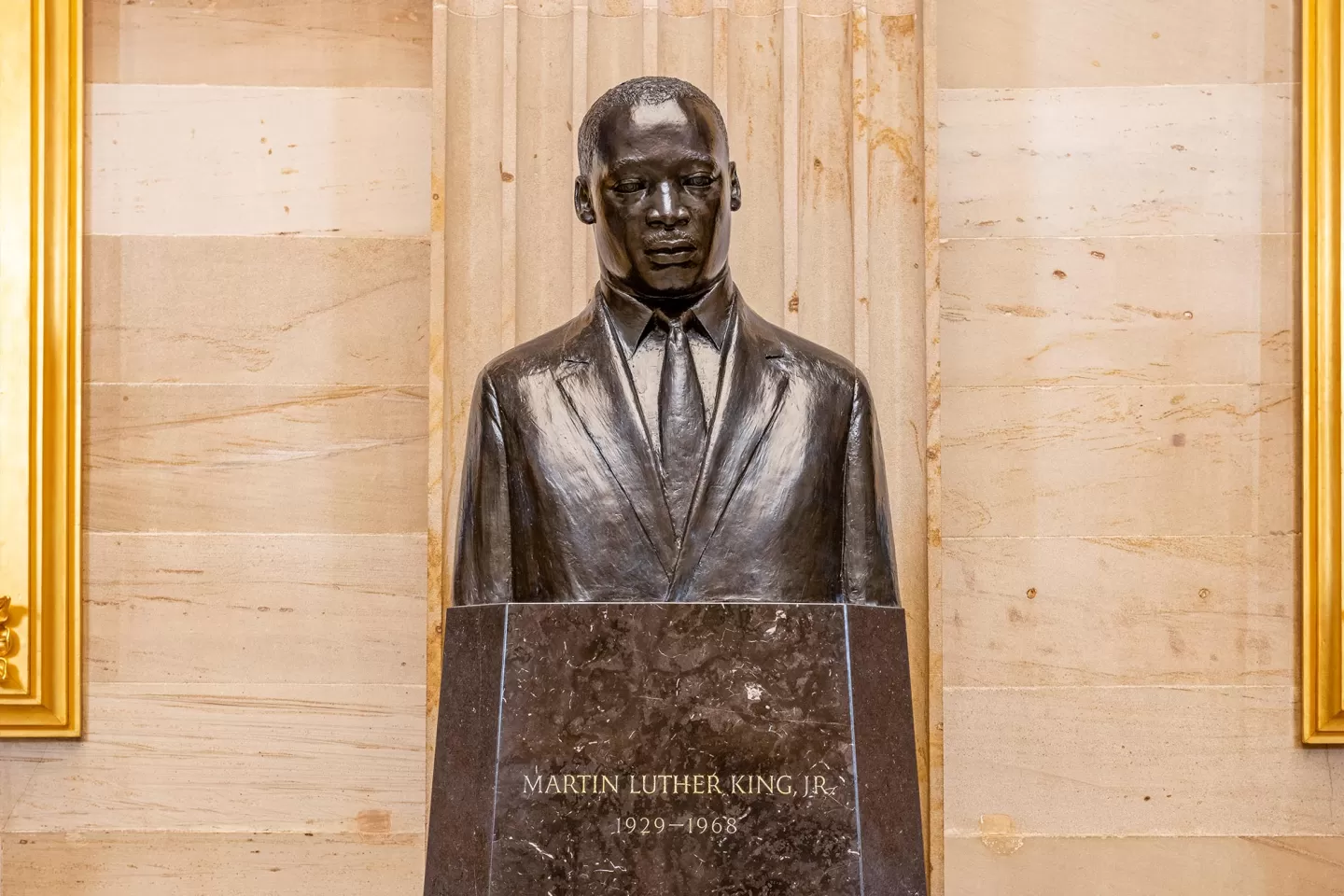 Bronze bust on a pedestal.