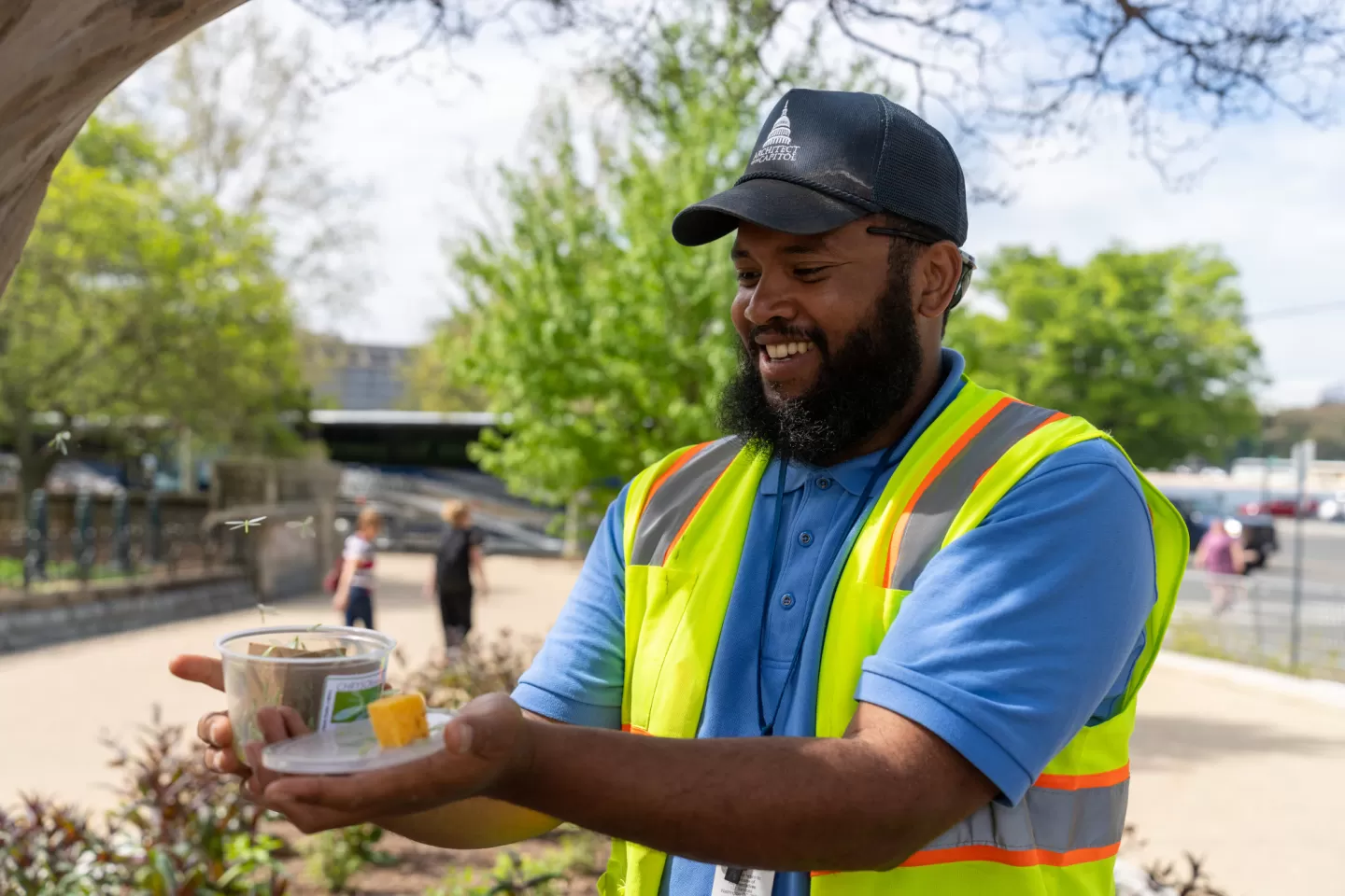 Person holding a container with the lid off.