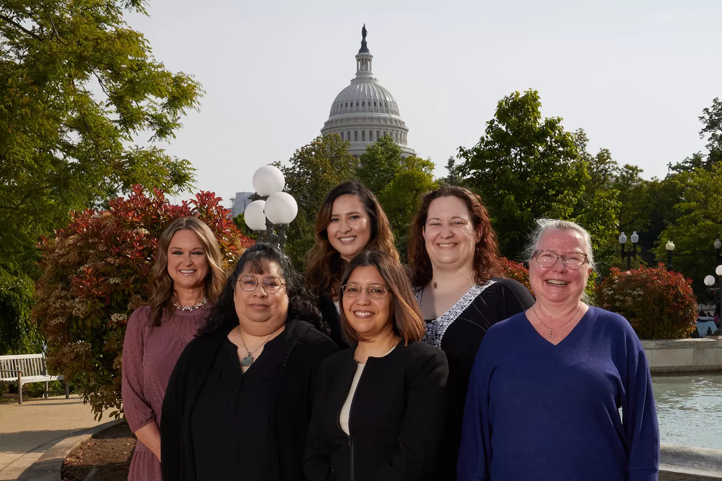 Group of people with the Capitol Dome in the background.