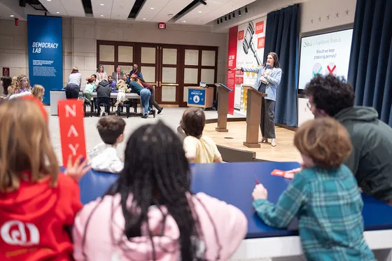 Group of kids listening to a presenter.