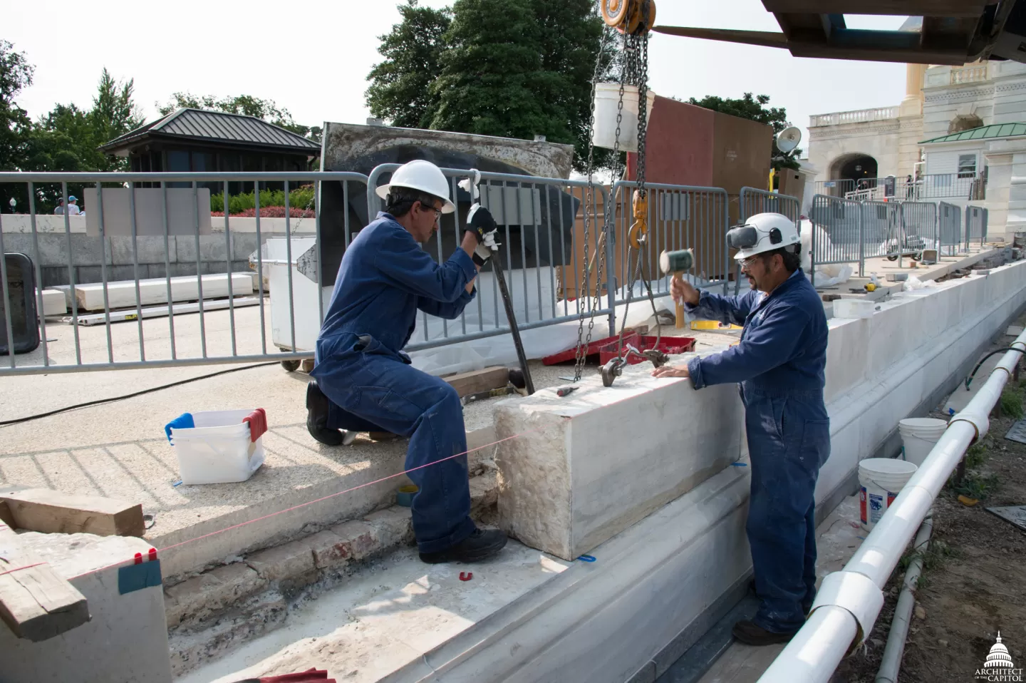 Two people working with stone.