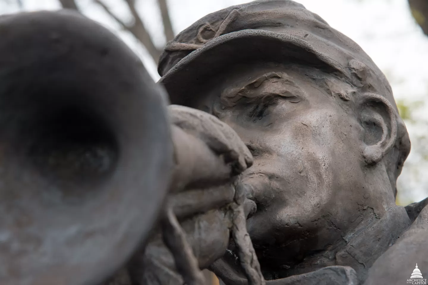 Sculpture detail of a person playing an instrument.