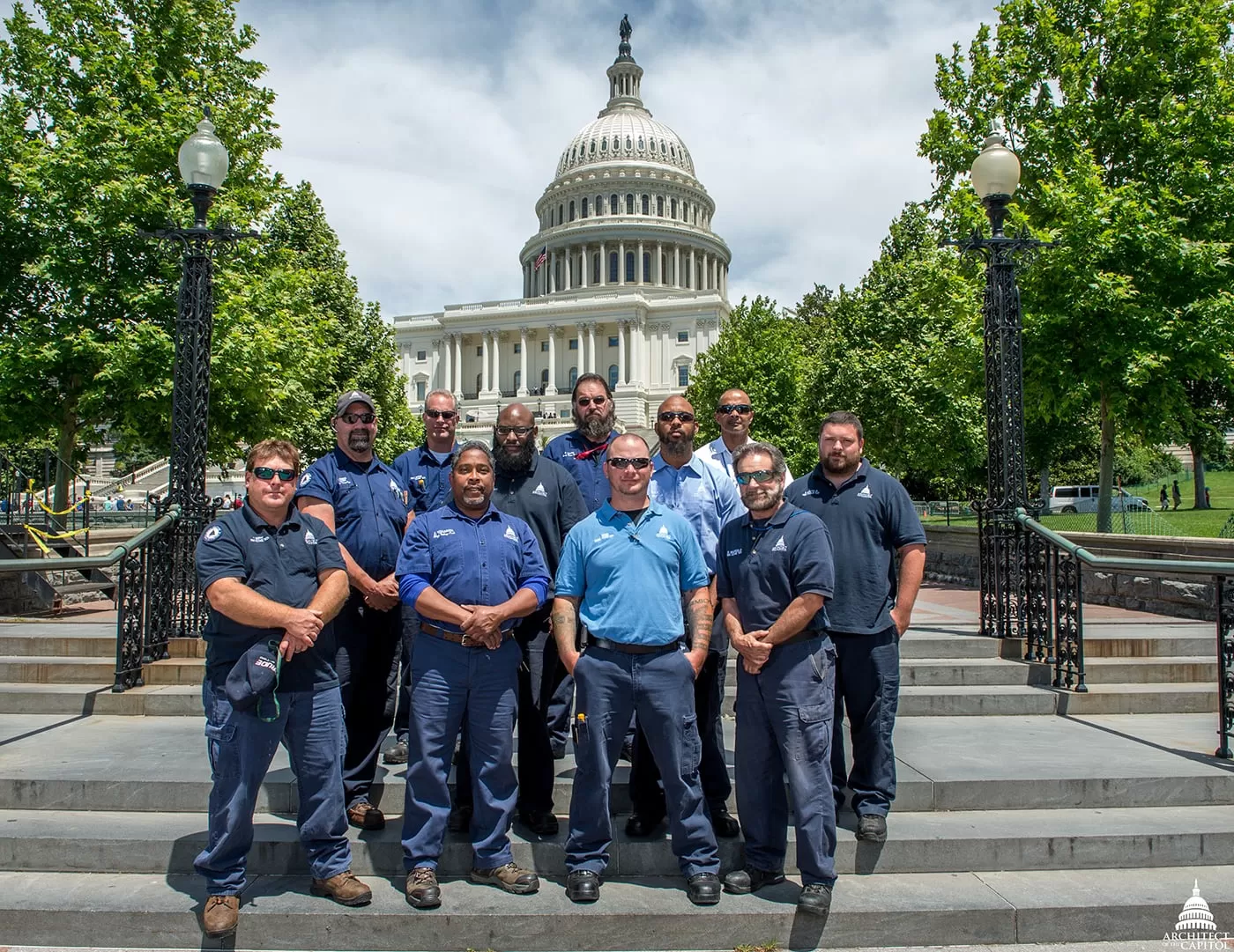 Group photo of the Architect of the Capitol high-voltage electricians on the West Front of the U.S. Capitol.