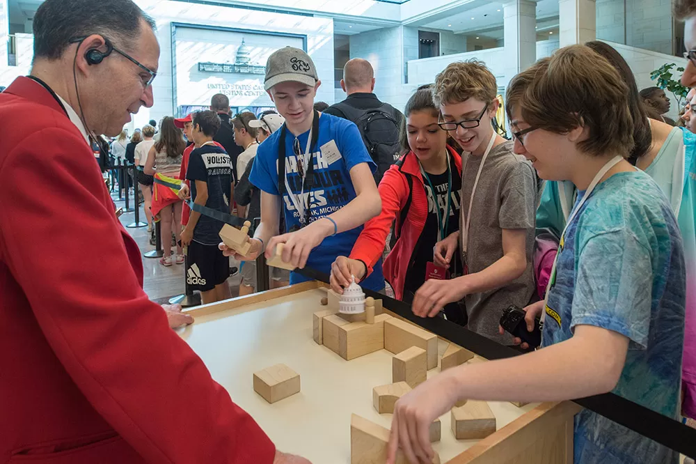 A visitor guide interacts with guests in the U.S. Capitol Visitor Center's Emancipation Hall.