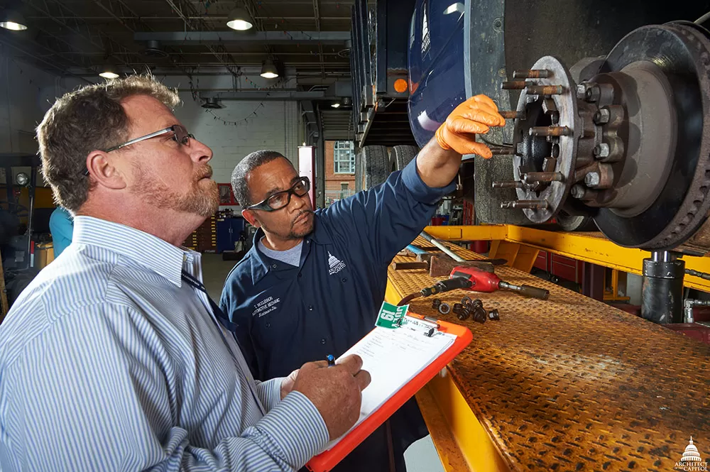 Members of Capitol Grounds and Arboretum inspect a vehicle operating on the U.S. Capitol campus.