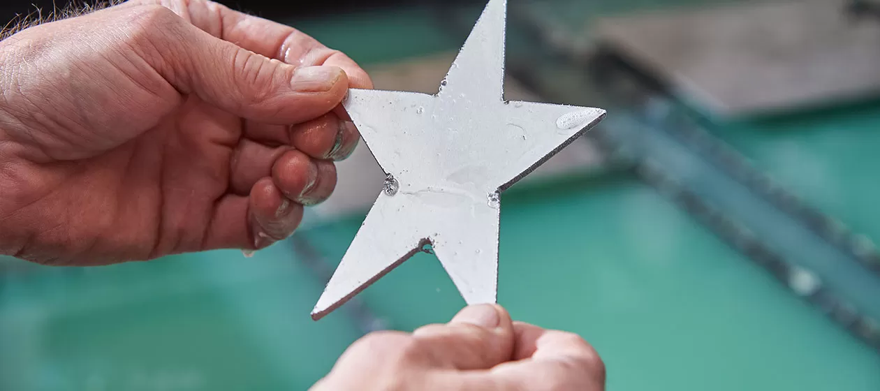 A five-pointed star was cut within seconds by the Architect of the Capitol Sheet Metal Shop.