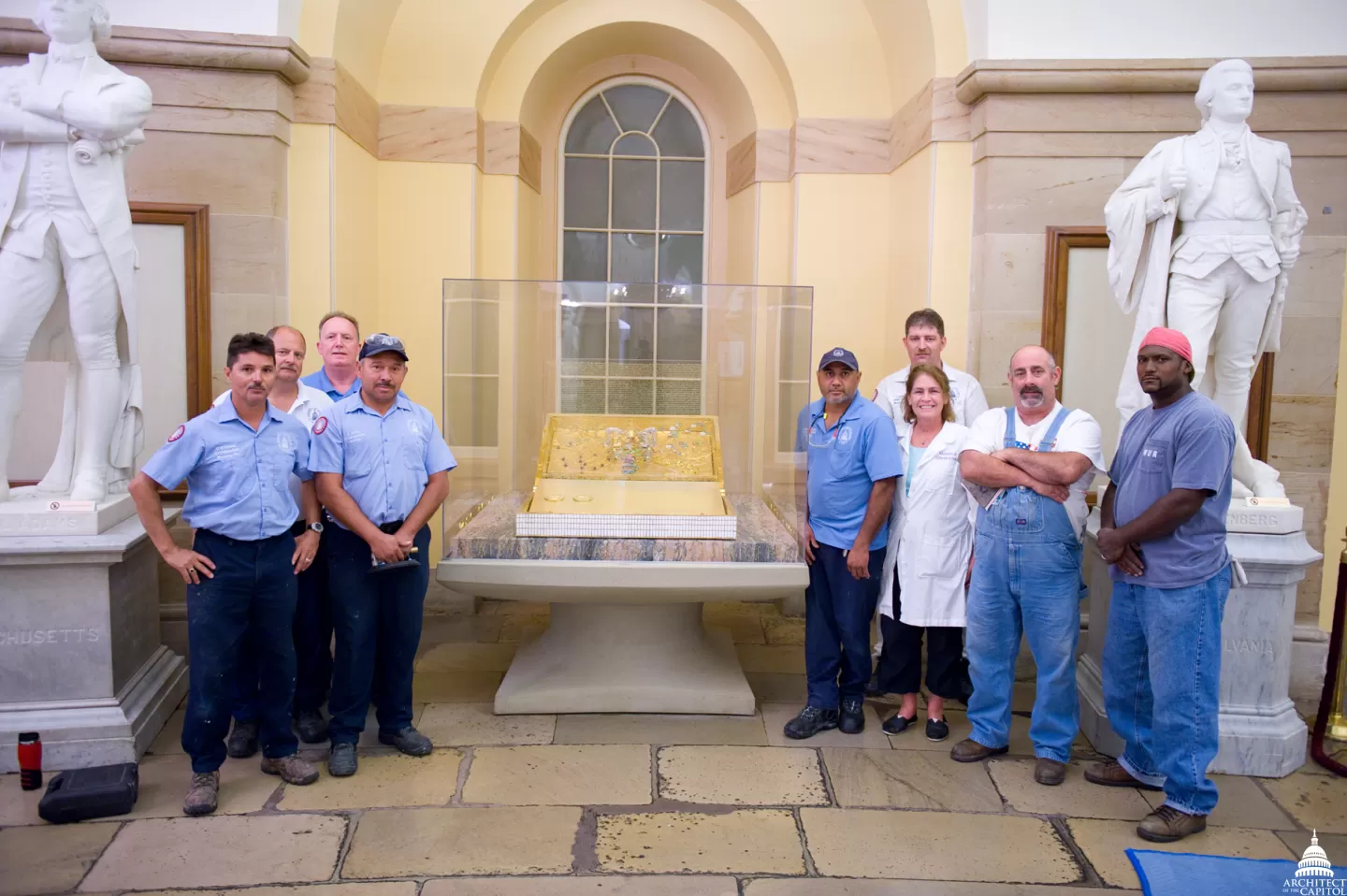 Group of people standing with statues.