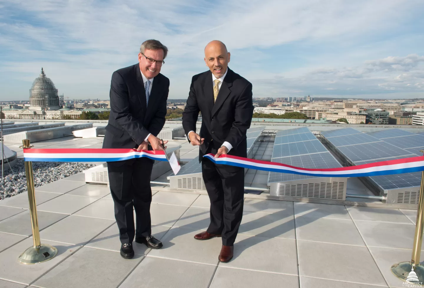 Two people at a ribbon cutting ceremony.