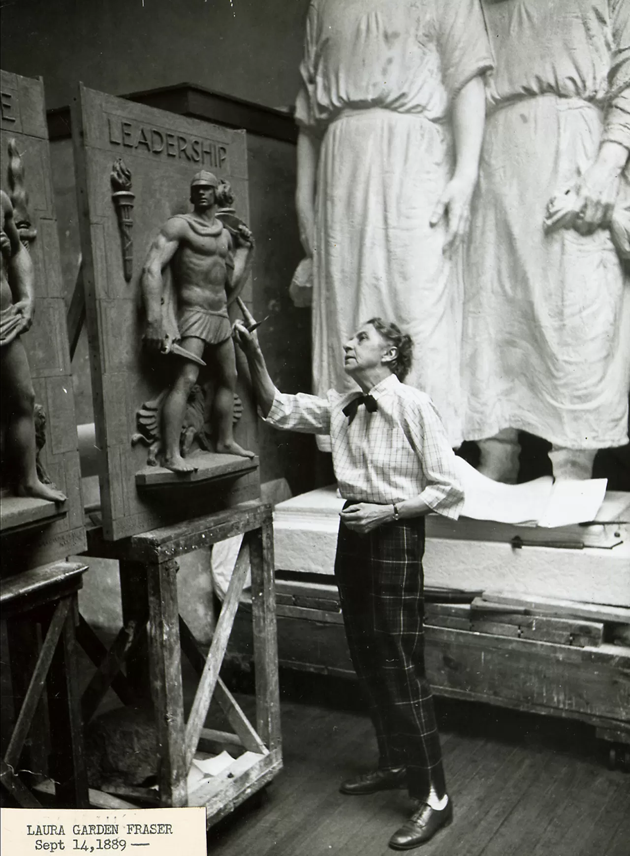 Person standing next to a sculpture.