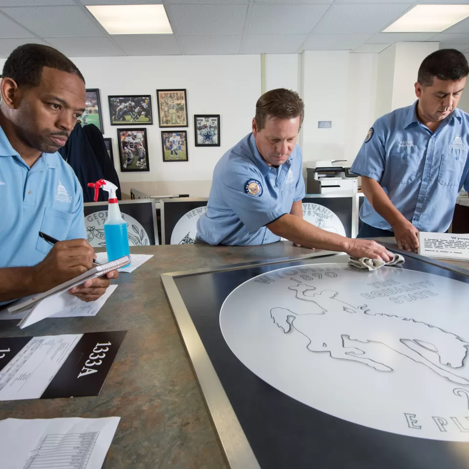 Three woodcrafters sketching a new design