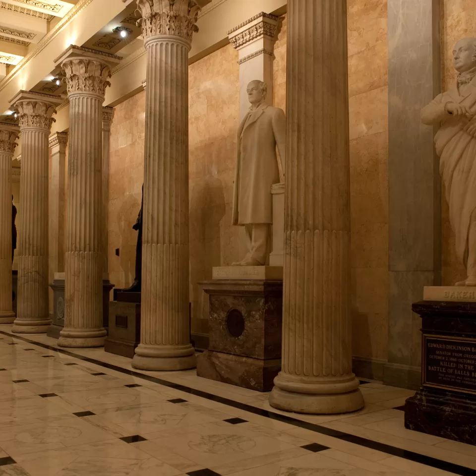 Columns in a room with statues.