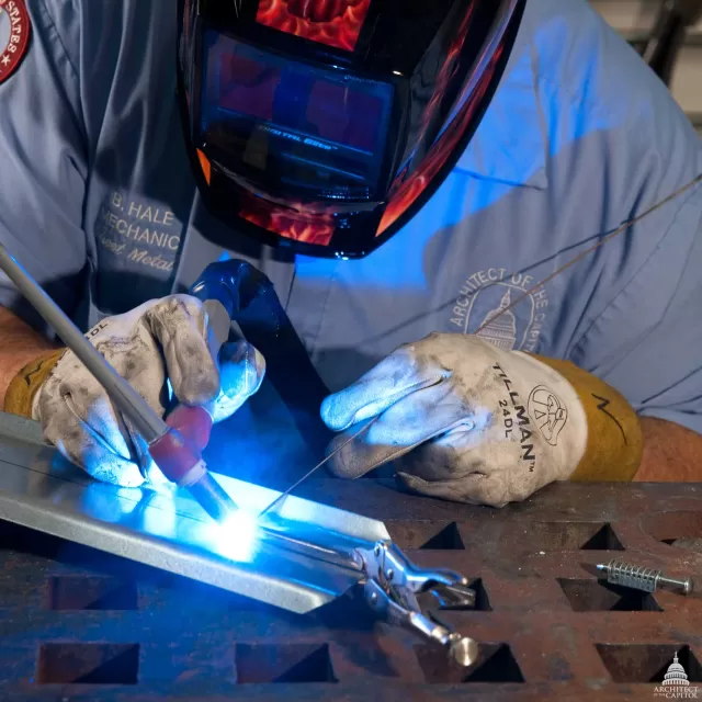 Metal worker working on sheetmetal