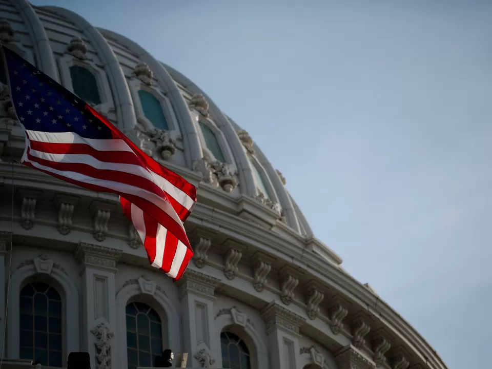 U.S. Flag in front of U.S. Capitol Dome