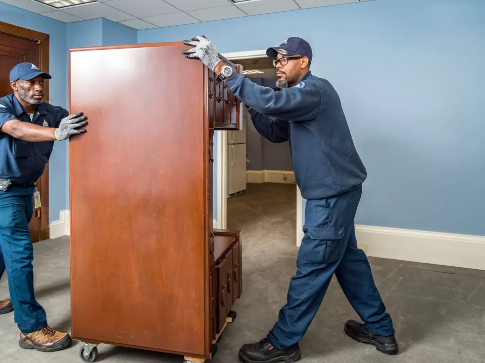 AOC employees move furniture in a Senate office building.