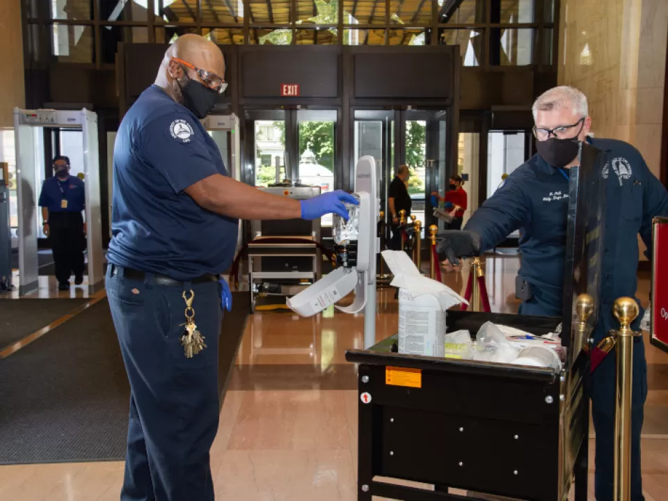 Robert Hollins and Roger Hall clean high-touch surface areas and work spaces in the Library of Congress buildings.